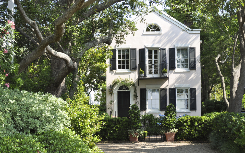 White two story home with green foliage